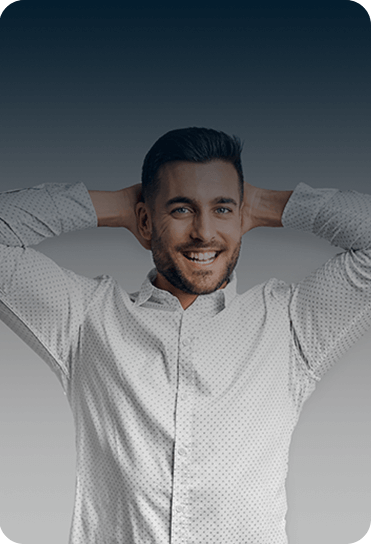 A man smiles, putting his hands behind his head