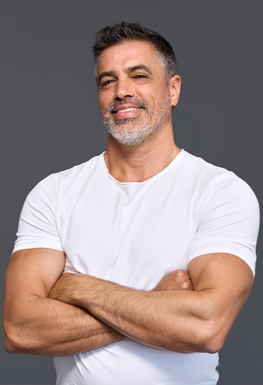 A middle-aged man stands confidently